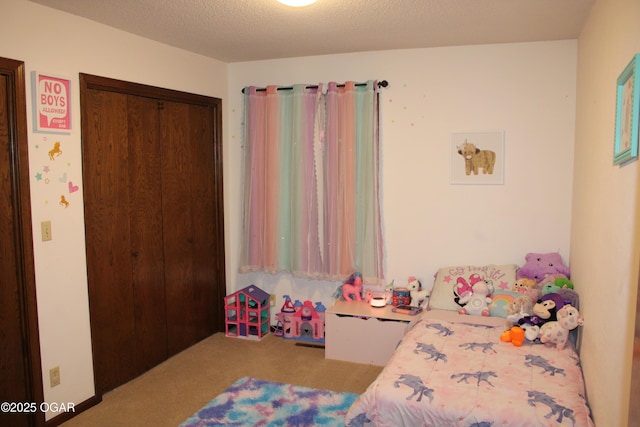 bedroom featuring a textured ceiling, a closet, and light colored carpet