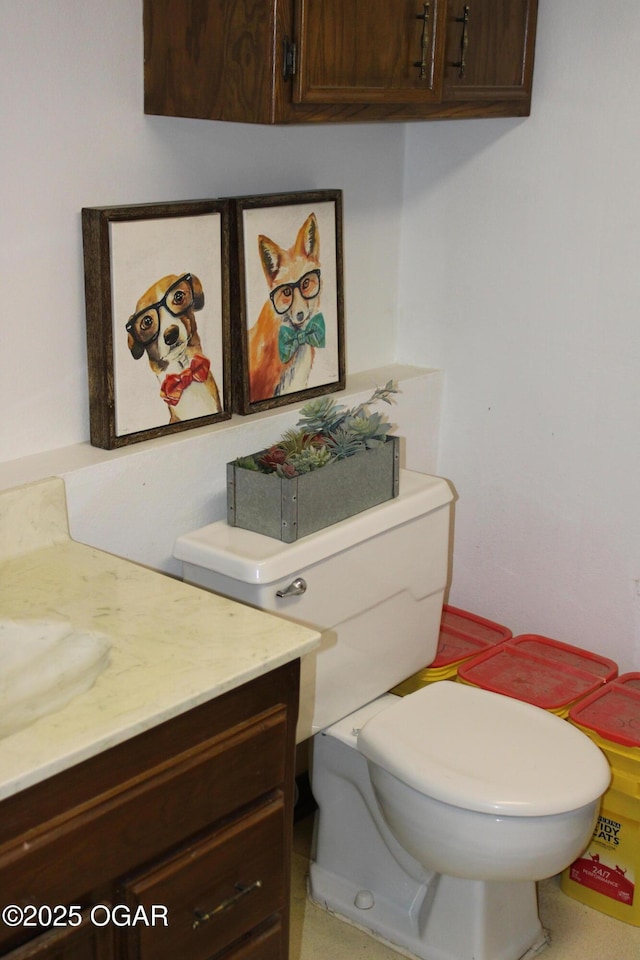 bathroom with toilet and vanity