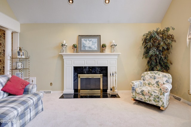 living room featuring carpet floors, a fireplace, and vaulted ceiling