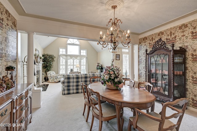 dining space featuring crown molding, lofted ceiling, light carpet, and ornate columns