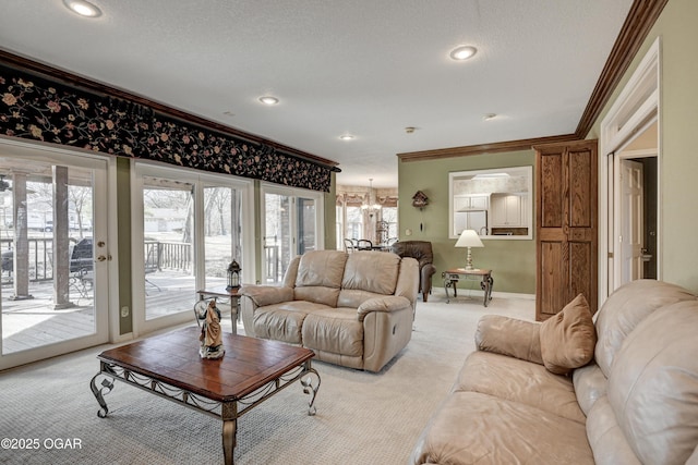 living room featuring crown molding, a wealth of natural light, light carpet, and a notable chandelier