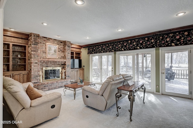 living room featuring built in features, crown molding, a brick fireplace, light carpet, and a textured ceiling