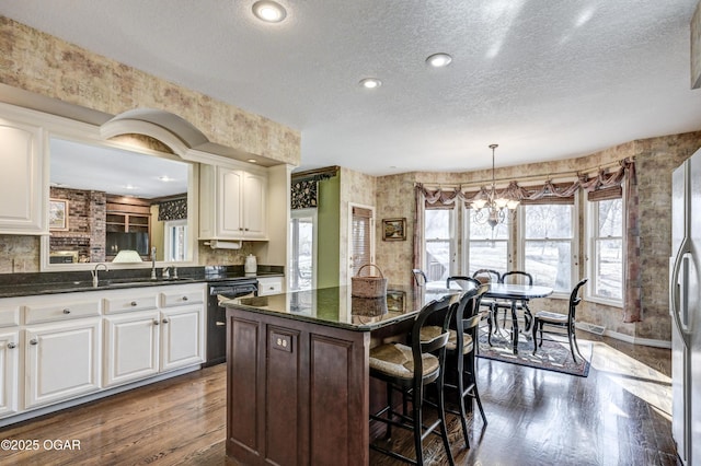 kitchen featuring a kitchen island, dark wood-type flooring, and white cabinets