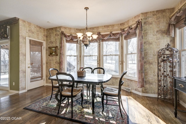 dining room featuring an inviting chandelier and dark hardwood / wood-style flooring