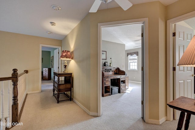 hall featuring light colored carpet