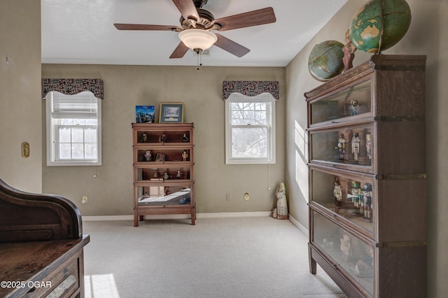 sitting room featuring light carpet and ceiling fan