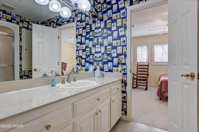 bathroom featuring vanity, a textured ceiling, tile patterned floors, and ceiling fan