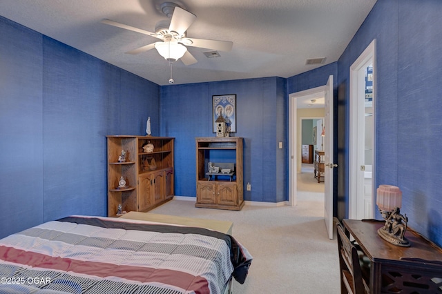 carpeted bedroom featuring a textured ceiling and ceiling fan