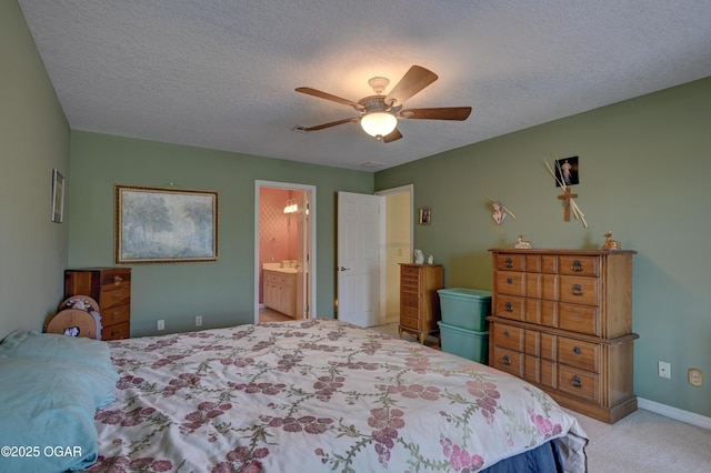 carpeted bedroom with connected bathroom, a textured ceiling, and ceiling fan