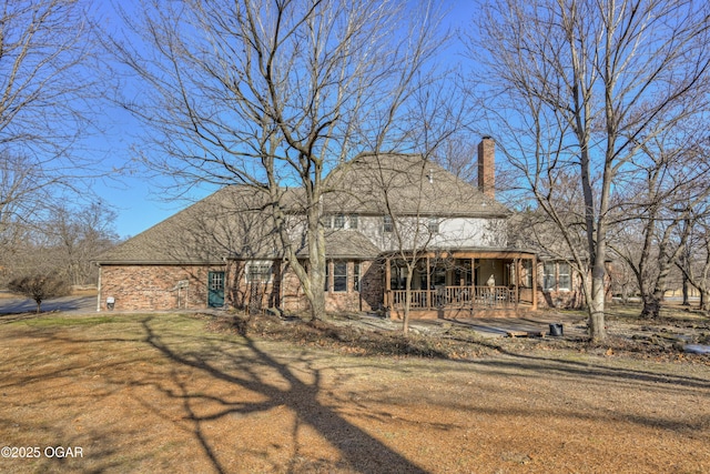 view of front facade featuring a front yard and a deck