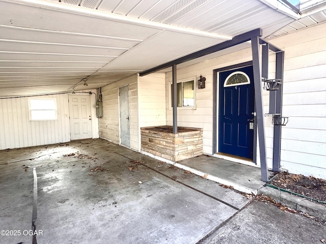 property entrance featuring a carport