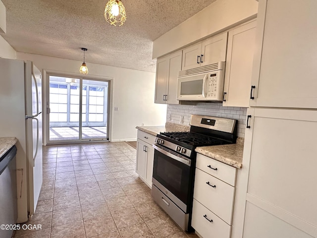 kitchen with decorative backsplash, a textured ceiling, stainless steel appliances, and pendant lighting