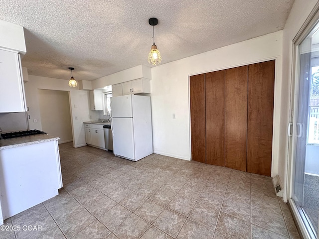 kitchen featuring pendant lighting, dishwasher, white cabinetry, white refrigerator, and sink