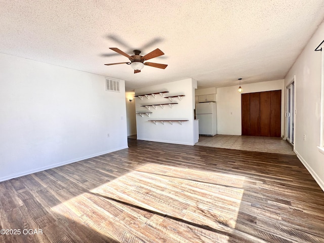 unfurnished living room with ceiling fan, wood-type flooring, and a textured ceiling