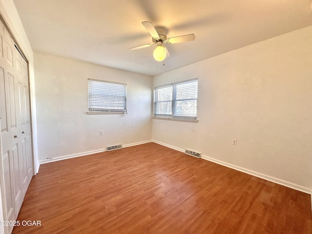 unfurnished bedroom featuring ceiling fan, a closet, and dark hardwood / wood-style floors