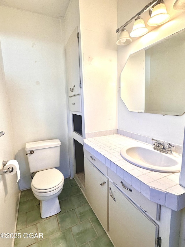 bathroom with toilet and vanity