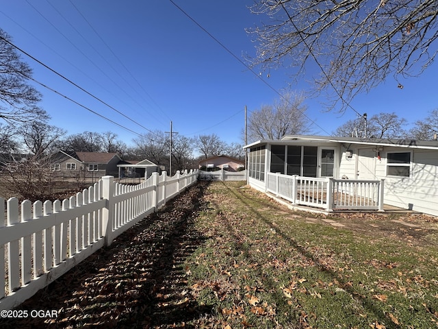 view of side of property featuring a sunroom