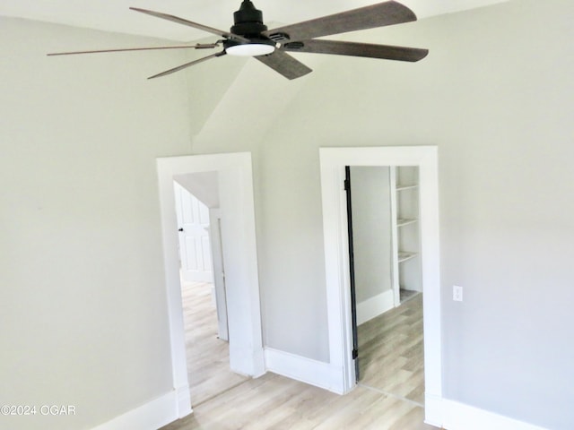 spare room featuring vaulted ceiling and light hardwood / wood-style flooring