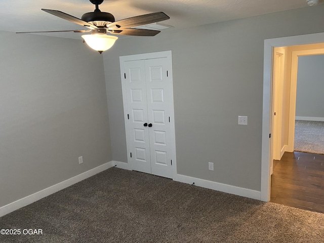 unfurnished bedroom with a closet, ceiling fan, and dark colored carpet