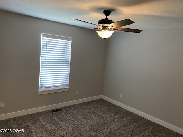 spare room featuring ceiling fan and carpet flooring