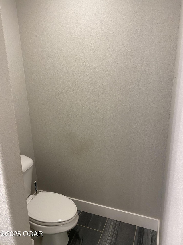 bathroom featuring tile patterned flooring and toilet