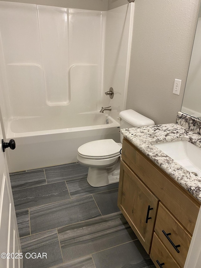 full bathroom with shower / bathtub combination, vanity, and toilet