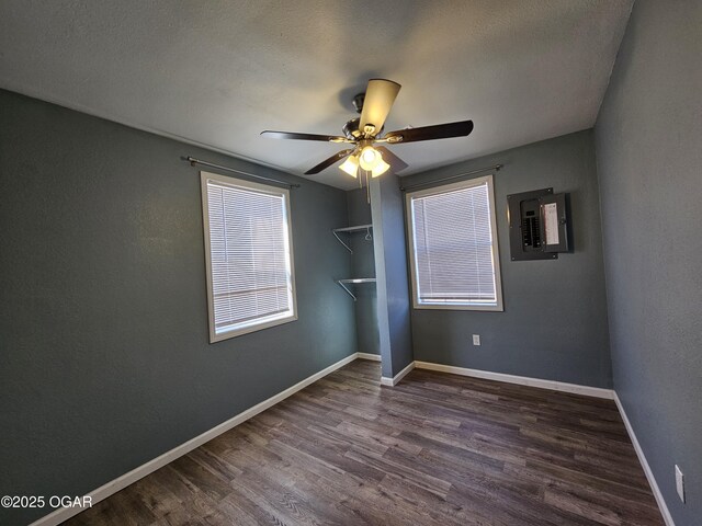 unfurnished bedroom featuring ceiling fan, dark hardwood / wood-style flooring, and a textured ceiling