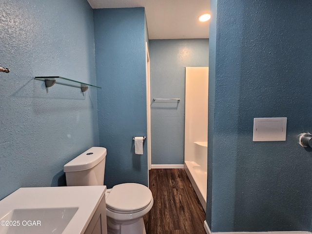 bathroom featuring hardwood / wood-style flooring and toilet