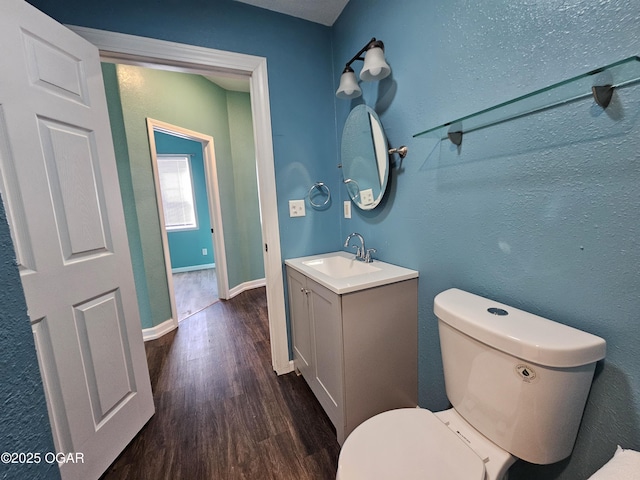 bathroom featuring hardwood / wood-style flooring, vanity, and toilet