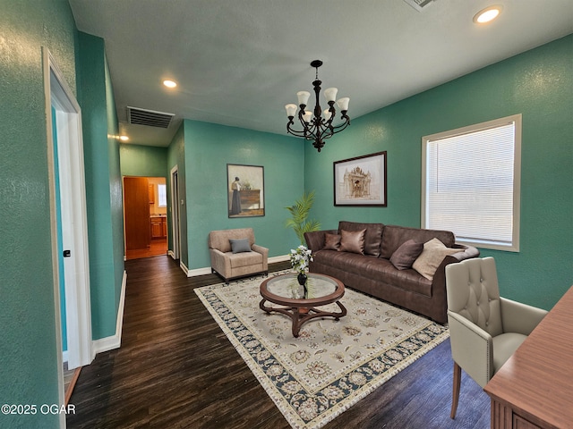 living room featuring dark wood-type flooring and a notable chandelier