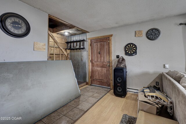 1101 N Anderson Ave, Joplin, MO 64801 - interior space featuring light wood-type flooring, a baseboard radiator, and a textured ceiling