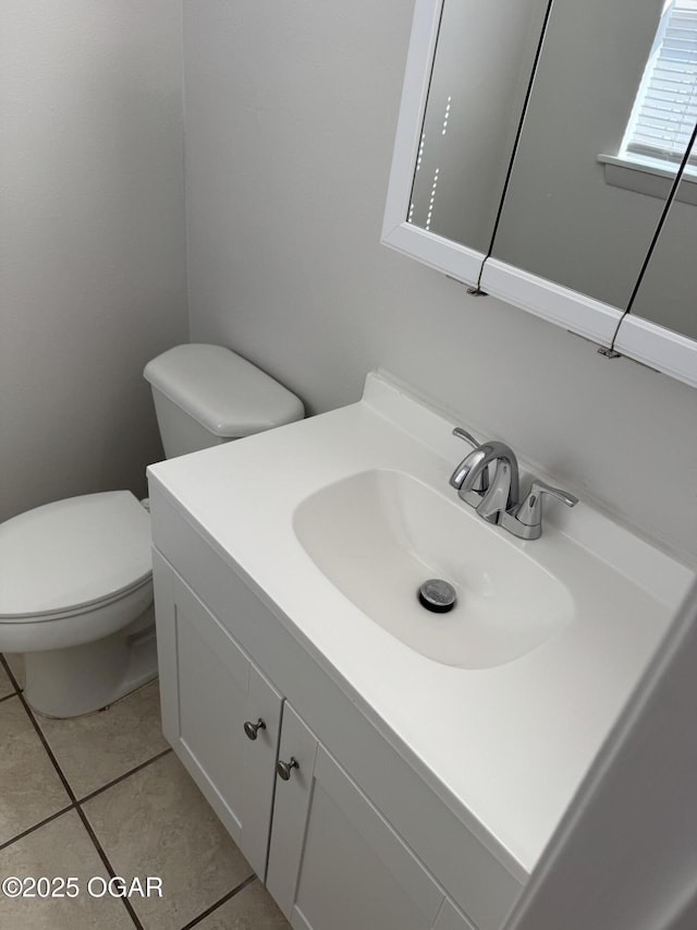 bathroom featuring vanity, tile patterned floors, and toilet