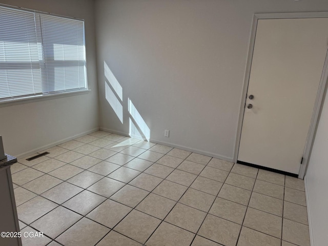 unfurnished room featuring light tile patterned floors