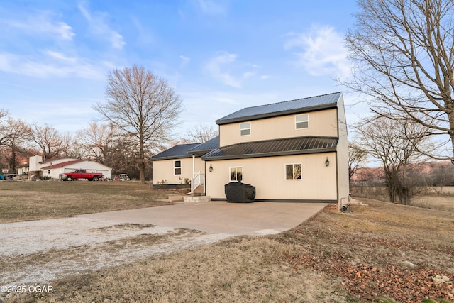 rear view of house with a patio area and a yard