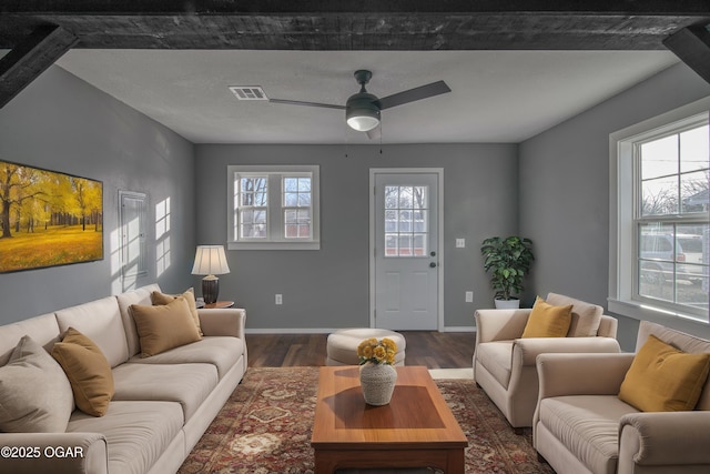 living room featuring ceiling fan and dark hardwood / wood-style floors