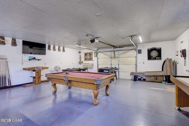 playroom featuring concrete floors and a textured ceiling