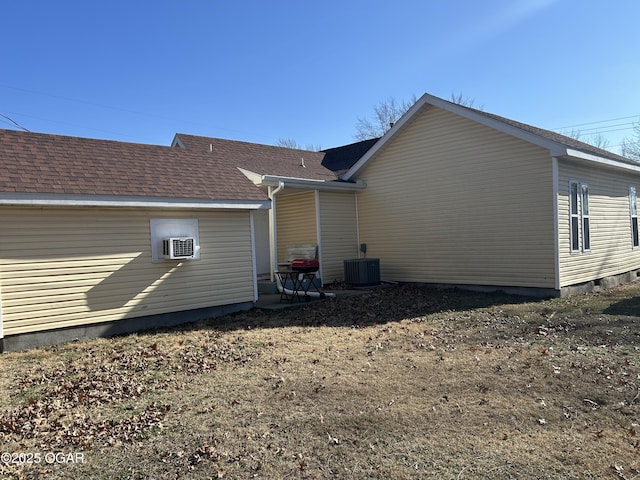 back of house featuring cooling unit and central AC unit