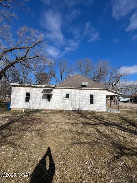 back of house with a lawn