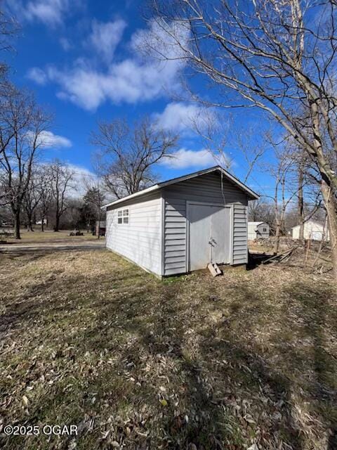 view of outbuilding featuring a yard