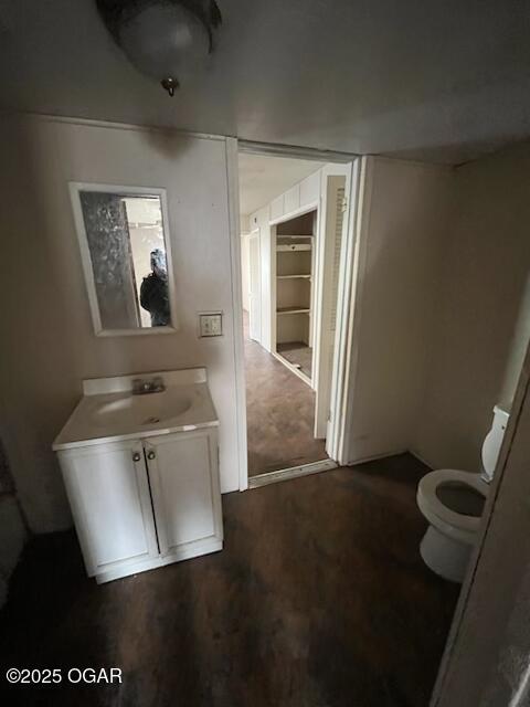 bathroom featuring vanity, toilet, and hardwood / wood-style floors