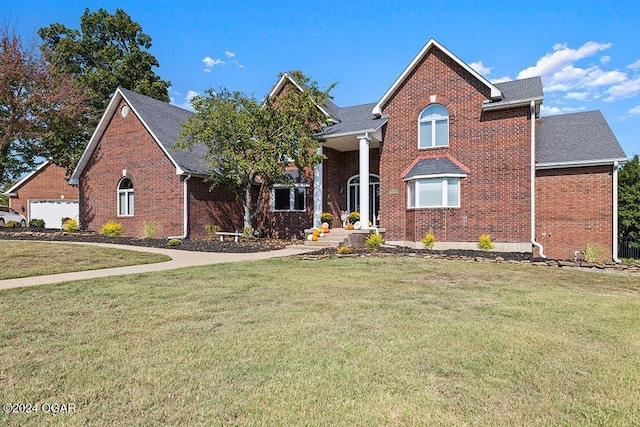 front of property featuring a garage and a front lawn