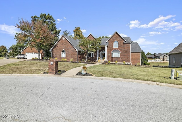 view of front property featuring a garage and a front lawn