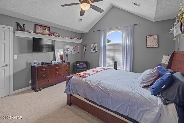 bedroom with ceiling fan, lofted ceiling, carpet floors, and a textured ceiling