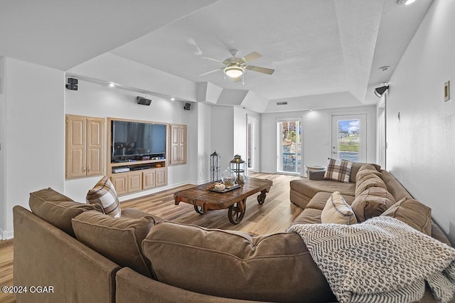 living room with ceiling fan and light hardwood / wood-style floors