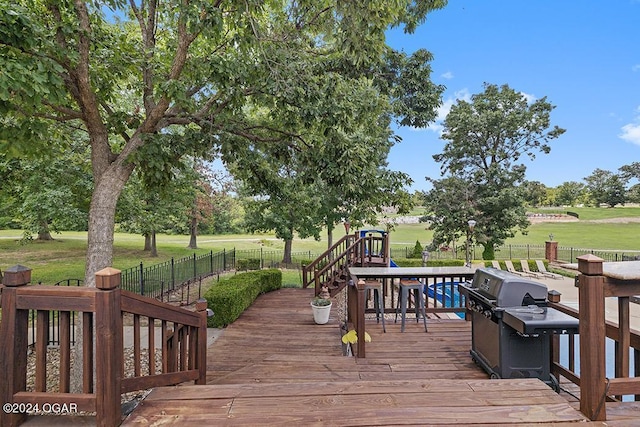 wooden terrace featuring a playground and a lawn