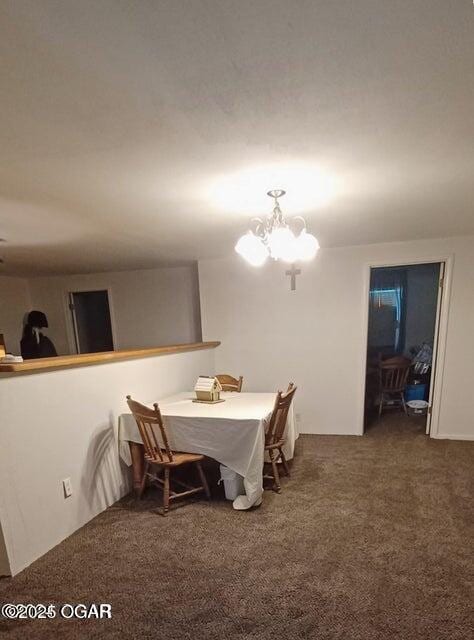 carpeted dining area featuring a chandelier