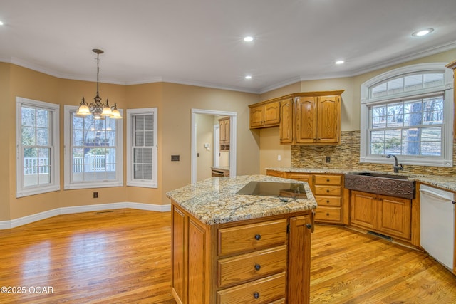 kitchen with a kitchen island, black electric stovetop, white dishwasher, and light hardwood / wood-style flooring