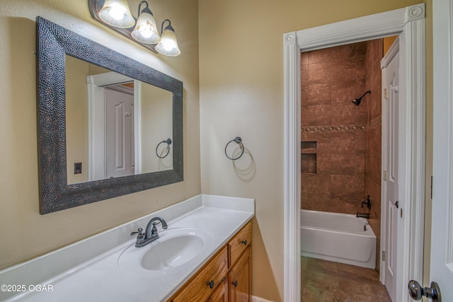 bathroom with tiled shower / bath combo and vanity