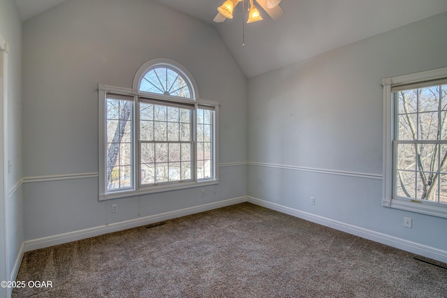 empty room with lofted ceiling, carpet flooring, and a wealth of natural light