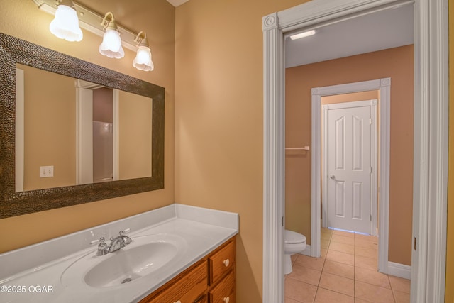 bathroom featuring vanity, tile patterned floors, and toilet